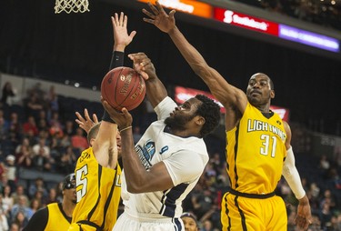 Halifax Hurricanes centre Rhamel Brown is fouled while being defended by London Lightning forward Garrett Williamson and Kirk Williams Jr. (31) during the second half of Thursday night’s NBL Canada playoff game in Halifax. The Hurricanes knocked off the Lightning 112-101 and will play Game 7 tomorrow night. 
(RYAN TAPLIN / The Chronicle Herald)