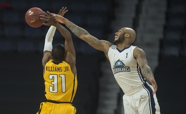 Halifax Hurricanes power forward Tyrone Watson knocks away the ball from London Lightning forward Kirk Williams Jr. during the first half of Friday night’s NBL Canada playoff game in Halifax. The Lightning led the Hurricanes 57-53 at the half.
(RYAN TAPLIN / The Chronicle Herald)