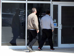 Josh Alexander, right, enters the provincial courthouse on Tuesday in Stratford. Terry Bridge/Stratford Beacon Herald/Postmedia Network