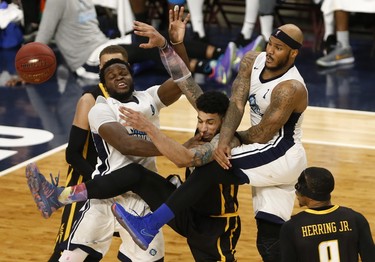 Halifax Hurricanes Rhamel Brown, left, and Tyron Watson, deny London Lightning’s Julian Boyd, centre, during NBL of Canada playoff action in Halifax Sunday. (Tim Krochak/ The Chronicle Herald)
