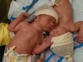 Brothers Caleb and Weston Lyman weren't ready to break their bond moments after birth in this viral video. (Facebook/Dane Lyman)