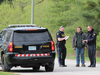 OPP officers on Friday talk with a resident of Front Road, where a body was found. (Dale Carruthers/The London Free Press)