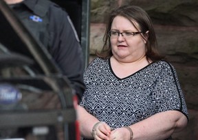 Elizabeth Wettlaufer is escorted by police from courthouse in Woodstock. (File photo)