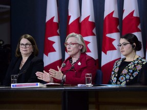 Carolyn Bennett, Minister of Crown-Indigenous Relations and Northern Affairs, speaks as she is joined by Jane Philpott, Minister of Indigenous Services, left, and Maryam Monsef, Minister of Status of Women, during a press conference at the National Press Theatre in Ottawa on Tuesday, in response to the Interim Report of the National Inquiry into Missing and Murdered Indigenous Women and Girls and the Commission's request for an extension. Sean Kilpatrick/The Canadian Press