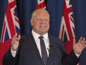 Ontario’s premier-designate Doug Ford appears before the media in Toronto on Friday after winning a majority government for the Progressive Conservative party. Stan Behal/Postmedia Network