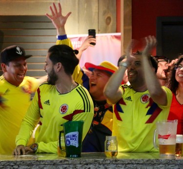 Several Colombian fans celebrate Colombia's first goal at The Bar and Barrel urban salon in downtown London on Sunday. Columbia was facing Poland in the group round of the tournament. (SHANNON COULTER, The London Free Press)