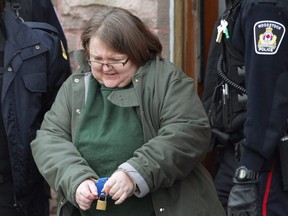 Elizabeth Wettlaufer is escorted from the courthouse in Woodstock, Ont., on Friday, Jan. 13, 2017. Ontario has announced an appeal court judge who will head a public inquiry into the policies, procedures and oversight of long-term care homes after a nurse admitted to killing eight seniors in her care. THE CANADIAN PRESS/Dave Chidley