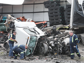 Ontario Provincial Police expected Hwy. 401 to remain closed at Tilbury until approximately 4:00 p.m. Friday after a horrific headon collision between two tractor-trailers. One driver is dead and the other in serious condition. (Postmedia)