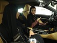 Modia Batterjee, right, asks questions of salesperson Haifa Alsehli while they sit in a Lexus car Batterjee  is interested in buying at a Lexus dealership the day after women were once again allowed to drive in Saudi Arabia (Sean Gallup/Getty Images)