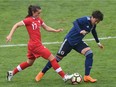 Japan's Yuika Hasegawa (R) vies with Canada's Jessie Fleming during the Algarve Cup football match between Japan and Canada at the Algarve stadium in Faro, on March 7, 2018.