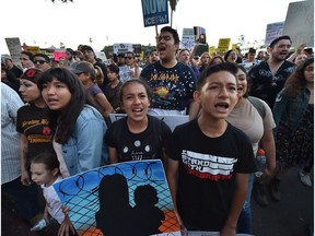 (FILES) In this file photo taken on June 14, 2018 Protestors chant outside the Metropolitan Detention Center where ICE (US Immigration and Customs Enforcement) detainees are held, during a 'Families Belong Together March' against the separation of children of immigrants from their parents, in downtown Los Angeles, California. The UN rights chief on June 18, 2018 condemned the "unconscionable" separation of migrant children from their parents at the US border, as First Lady Melania Trump made a rare political plea to end the deeply controversial practice. The "zero-tolerance" border security policy implemented by President Donald Trump's administration has sparked tears among migrant families and outrage on both sides of the political aisle.It took on particular resonance as America celebrated Father's Day.