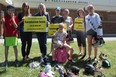 Londoners in Old South are rallying to save the ice pads at Farquharson arena, which they say is an integral part of the community. (L-R) James Colquhoun, Lisa Conley, Lisa Nelson, Ethan Saunders, Isabella Colquhoun, Heather Saunders, Lori-Ann Pizzolato and Keira Hurry all skate at the arena or help to run free community skating events. (MEGAN STACEY/The London Free Press)