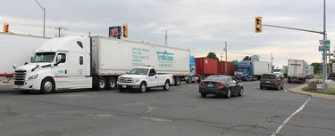 Traffic was diverted through the heart of Tilbury, Ont. after two tractor trailers collided head-on in a crossover crash on Hwy. 401 just before 7 a.m. on Friday June 22, 2018.  (Ellwood Shreve/Postmedia Network)