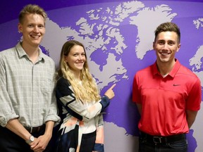 Dalhousie University's team Eric Dunn (left), Meredith Frasier and Brett Lindenfield point out their school's province, Nova Scotia, on a mural outside their practice room at Western University. Their idea for the World's Challenge Challenge is to grow algae on maritime shipping boats in huge tanks, in order to reduce the amount of carbon emissions. (SHANNON COULTER, The London Free Press)