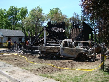 Chesley and Area Fire Department members assist a member of the fire marshal's office with cleanup and sorting through rubble on Tuesday after a house fire claimed three lives in Chesley early Monday morning. After finding the bodies on Monday the focus of the investigation shifted on Tuesday to determining the cause of the fire. (DEREK LESTER, Postmedia Network)