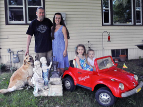 Craig and Melanie Kernaghan, shown with their children Sophia, 4, and Robinson, 1, and their dog Daisy, were chatting with two neighbours at their home in the Tillsonburg-area town of Courtland on Monday afternoon when lightning struck. Melanie Kernaghan says her heart stopped and she was knocked unconscious.  JACOB ROBINSON/Postmedia Network