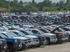 GM vehicles are seen in a parking lot at its Oshawa Assembly Plant in Oshawa, Ont.