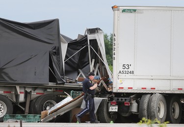 The wreckage of a collision between two tractor-trailers is shown on Friday, June 22, 2018 on Highway 401 near Tilbury, ON. One driver was killed and the other is in serious condition. The accident occurred just before 7:00 a.m. and shut down all lanes of the highway for several hours. (DAN JANISSE/THE WINDSOR STAR)