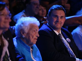 Former Mississauga mayor Hazel McCallion sits front and centre with Toronto city councillor Michael Ford before Ontario's Premier Doug Ford came on stage to address his supporters at the Toronto Congress Centre on Thursday night. (Jack Boland/Postmedia Networ)
