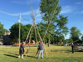 A crew assembles a tipi on The Green in Wortley Village Thursday morning for Indigenous Solidarity Day.