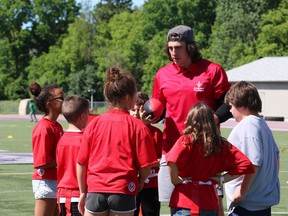 Luke Willson gathers his team for a group huddle during a game of flag football at London's Jumpstart Games on Friday. (SHANNON COULTER, The London Free Press)