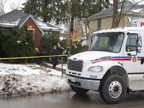 A London police officer leaves 56 Duchess Ave. in the days after the fatal 2016 London police shooting of Samuel Maloney. (File photo)