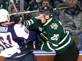 Adrian Carbonara of the Knights hammers Luke Boka of the Windsor Spitfires in this 2017 file photo.
