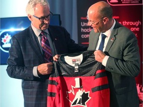 Tom Renney of Hockey Canada hands London mayor Matt Brown a jersey after it was announced that the Hockey Canada Foundation gala will be held in London. (Free Press file photo)