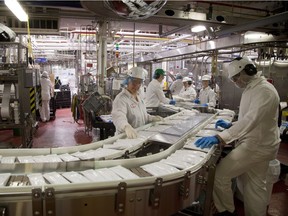 Workers on the Nestle ice cream bar work on the line.  The London plant produces 98% of Nestle's Canadian ice cream production. Mike Hensen/The London Free Press