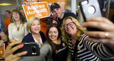 NDP leader Andrea Horwath gets into a selfie with Courtney Rup, DJ Lacey and Julie Kotis at the Jordan McGrail election office in Chatham during a campaign stop on Monday. Even Tank, a Boston terrier, got into the frame. Mike Hensen/The London Free Press/Postmedia Network