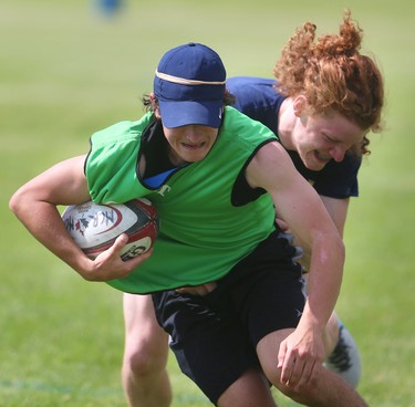 Collin Smibert of the Medway Cowboys tackles Noah Coleman during their last practice before the OFSAA AAA boys' rugby tournament starts Thursday at the St. George's rugby fields in London.  The Cowboys are hosting this year's provincial championship featuring the best teams from across Ontario, and the Cowboys are ranked No. 1 coming in. Mike Hensen/The London Free Press