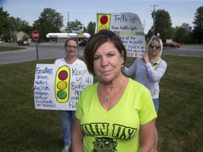 Cindy Beckett, left, Lucan Biddulph mayor Cathy Burghardt-Jesson, and Laura Colby want traffic lights installed at Highway 4 and Saintsbury Line in Lucan.  (DEREK RUTTAN, The London Free Press)