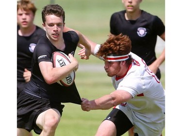 Cooper Grau of the Cowboys  manages to grab a bit of the jersey of Oakville Trafalgar's Chris Elliott during their semifinal at the St. George's Rugby fields on Friday. The Medway Cowboys punched their ticket for the gold medal game at OFSAA's AAA boys rugby by beating Oakville Trafalgar 20-0 on Friday in the semi's to get the chance at Brantford's St. John's College.  Mike Hensen/The London Free Press/Postmedia Network