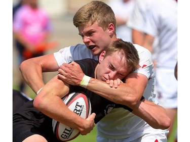 Ian Bennett of the Cowboys stops the run of Oakville Trafalgar's Andrew Easson during their semifinal at the St. George's Rugby fields on Friday. The Medway Cowboys punched their ticket for the gold medal game at OFSAA's AAA boys rugby by beating Oakville Trafalgar 20-0 on Friday in the semi's to get the chance at Brantford's St. John's College.  Mike Hensen/The London Free Press/Postmedia Network