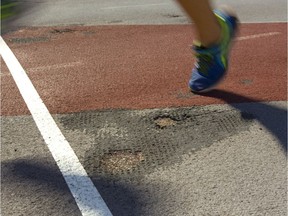 Holes are worn right through to the concrete at the start of the 100m dash line at the TD stadium track at Western University in London, Ont.  Photograph taken on Thursday June 14, 2018.  Mike Hensen/The London Free Press/Postmedia Network