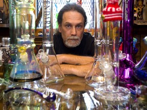 Mike McDowell of The Hippy Co. on Adelaide Street just south of Hamilton Road in London, Ont. with a sample of the glassware he sells in his shop. Photograph taken on Monday June 25, 2018.  Mike Hensen/The London Free Press/Postmedia Network