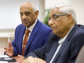 Vinay Sharma, CEO of  London Hydro board with Mohan Mathur talks to the editorial board of the London Free Press in London.  (Mike Hensen/The London Free Press)