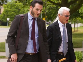 Brett and John Hueston, editor and publisher of the Aylmer Express, enter the court in St. Thomas on Wednesday. They are charged with criminal obstruction of a police officer, from an incident last year. (Mike Hensen/The London Free Press)