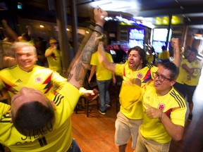 Colombian fans in London celebrate their goal against Senegal at the The Bull & Barrel on Talbot Street on Thursday.  (MIKE HENSEN, The London Free Press)