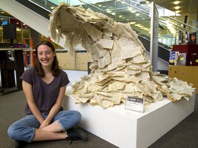 Kaitlyn German, 17 of Beal Art is proud that her Wave sculpture which is built out of over 200 paperbacks that were destined for the trash heap at the Stoney Creek library where she works. German saw the books as a perfect medium for her Beal Art project. (Mike Hensen/The London Free Press)