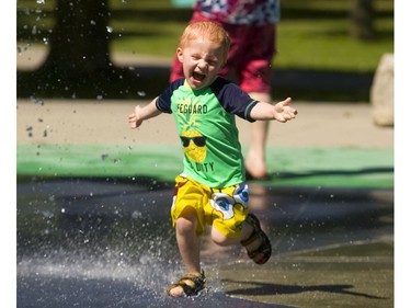 Chase Smith, 3, runs headlong into the splashpad in Gibbons Park on Friday. Chase, who was taken to the park with his older brother Carson by his dad Tom Smith, seemed to enjoy the cool respite from the high temperatures that started early Friday. (Mike Hensen/The London Free Press)
