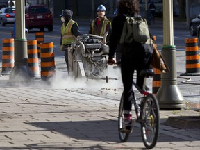 A cyclist pedals on the sidewalk (Postmedia file photo)