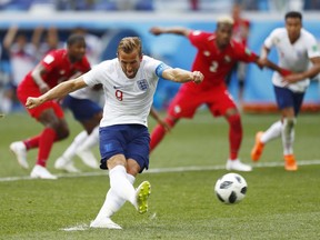 England's Harry Kane kicks a penalty to score his team's second goal during the group G match between England and Panama at the 2018 soccer World Cup at the Nizhny Novgorod Stadium in Nizhny Novgorod , Russia, Sunday, June 24, 2018. (AP Photo/Matthias Schrader)
