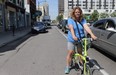 Shelley Carr, a cycling advocate in London, rides her bike alongside traffic on King Street. (SHALU  MEHTA/THE LONDON FREE PRESS)