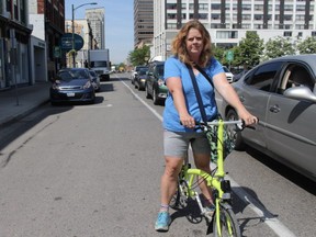 Shelley Carr, a cycling advocate in London, rides her bike alongside traffic on King Street. (SHALU  MEHTA/THE LONDON FREE PRESS)