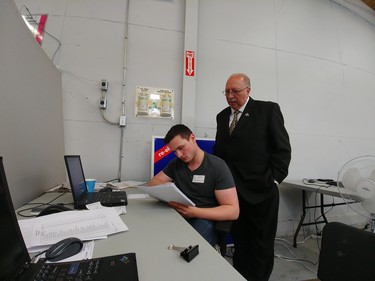 PC candidate Bob Bailey checks numbers with Andrew Esser at his campaign office Thursday. PAUL MORDEN, Sarnia Observer