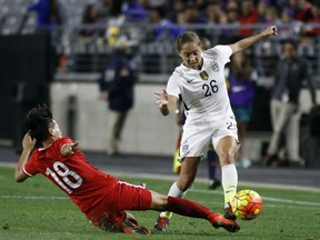 In this 2015 file photo, China's Han Peng (18) slides in to knock the ball away from United States' Jaelene Hinkle during the second half of an international friendly soccer match. Hinkle revealed she decided not to play for the U.S. women's national team last year because her Christian faith prevented her from wearing a jersey that commemorated LGBTQ Pride Month. Hinkle revealed the reason for her decision in an interview posted Wednesday on The 700 Club website. (AP file photo)