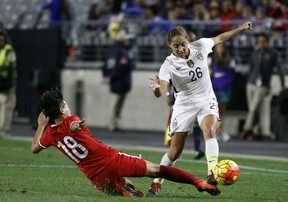 In this 2015 file photo, China's Han Peng (18) slides in to knock the ball away from United States' Jaelene Hinkle during the second half of an international friendly soccer match. Hinkle revealed she decided not to play for the U.S. women's national team last year because her Christian faith prevented her from wearing a jersey that commemorated LGBTQ Pride Month. Hinkle revealed the reason for her decision in an interview posted Wednesday on The 700 Club website. (AP file photo)