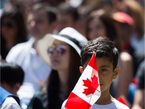 A young boy holds a Canadian flag while watching a special Canada Day citizenship ceremony in West Vancouver, B.C., on Saturday, July 1, 2017. Canada can be proud - but it must also be vigilant.