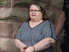 Elizabeth Wettlaufer is escorted by police from the courthouse in Woodstock. (File photo)